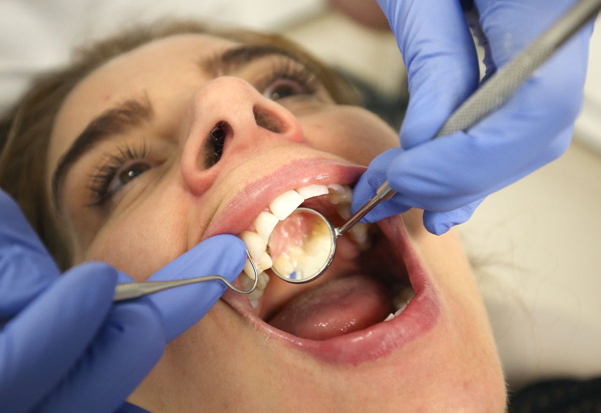 A patient having a hygiene appointment in a treatment room at The Dental Cafe.